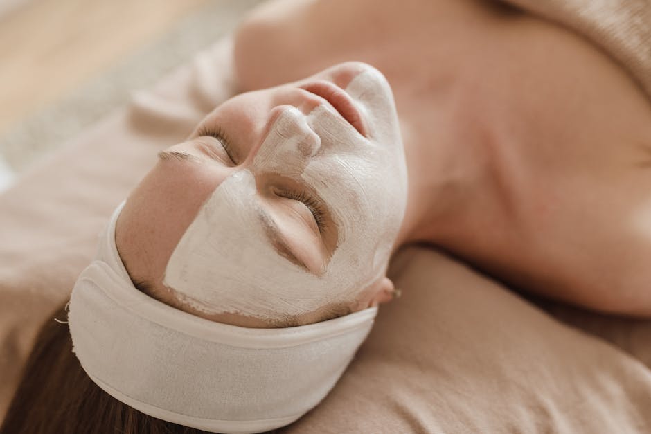 A serene woman enjoying a skincare treatment with a facial mask at a spa