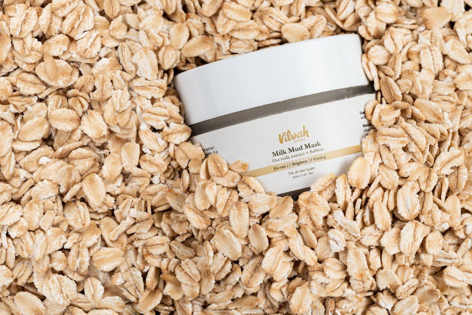 Top view of Vilvah Milk Mud Mask jar surrounded by rolled oats for skincare and wellness