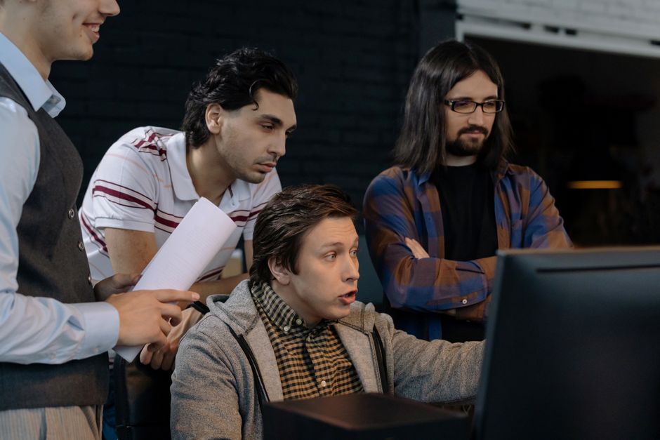 A diverse group of adults working together in a modern office environment.